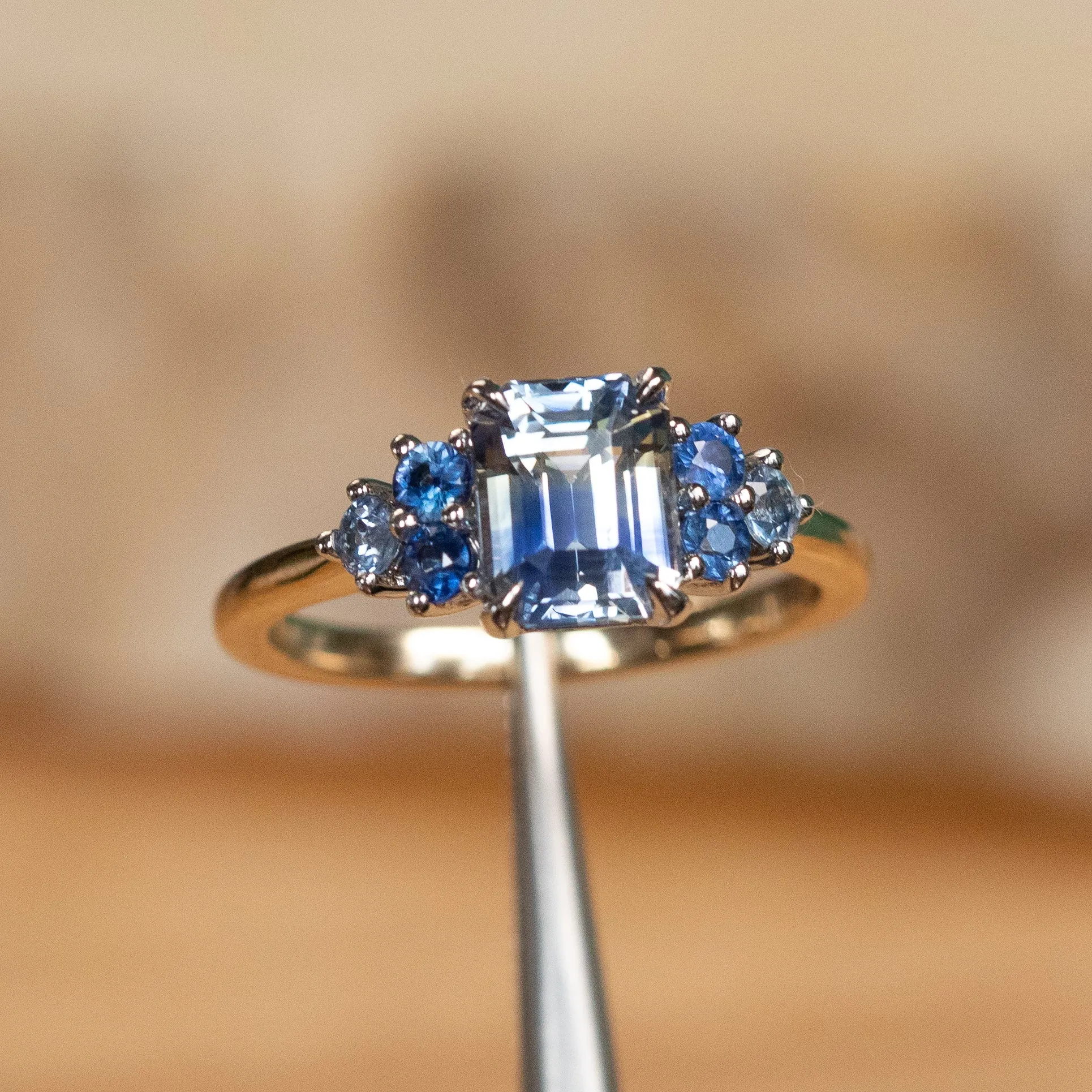 2.02ct Emerald Cut Bicolor Sapphire and Blue Sapphire Side Stone Cluster Ring in Two Tone 14k Yellow and White Gold