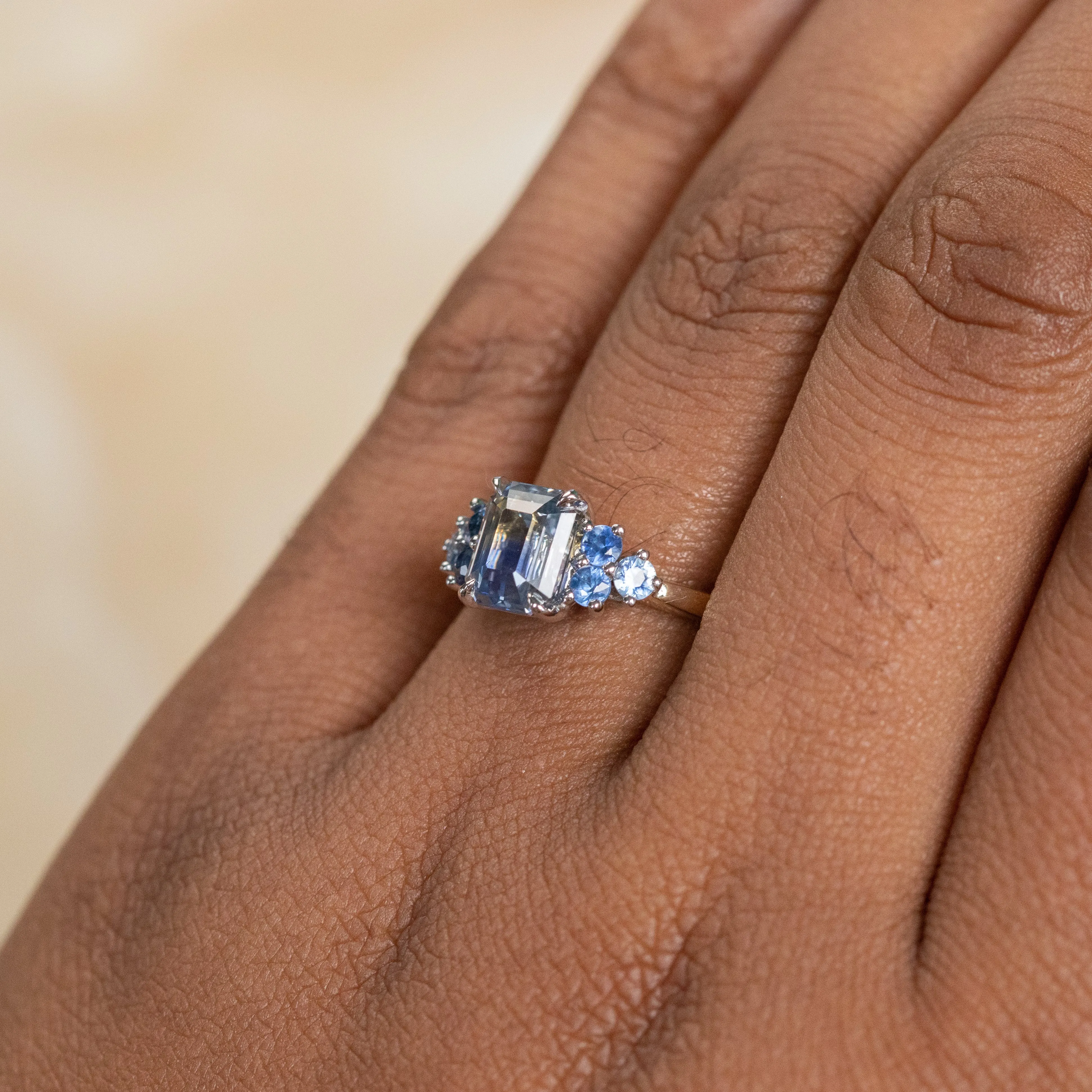 2.02ct Emerald Cut Bicolor Sapphire and Blue Sapphire Side Stone Cluster Ring in Two Tone 14k Yellow and White Gold